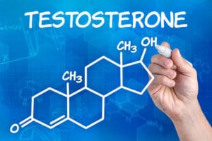 hand with pen drawing the chemical formula of testosterone